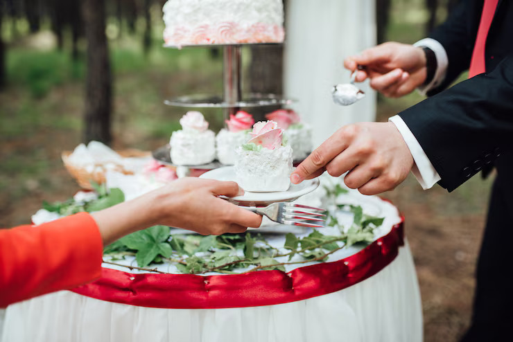 newlyweds-happily-cut-laugh-taste-wedding-cake_419896-8302